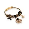 Bracciale rigido con charm nero e dorato albero della vita