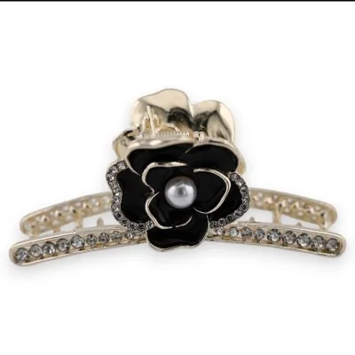 Goldene, rosa und schwarze Haarspange mit Strass