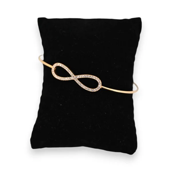 Gold-plated steel bangle bracelet with infinity symbol and rhinestones