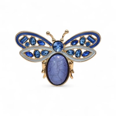 Broche mariposa en esmalte azul con alas en azul real y blanco perla, cristales azules facetados, cuerpo cabuchón ovalado lavand