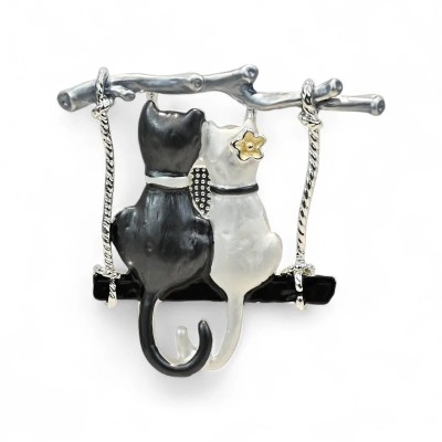 Silver-tone cat couple brooch with two cats seen from behind sitting on a swing made of a black enamel plank hung from a tree br