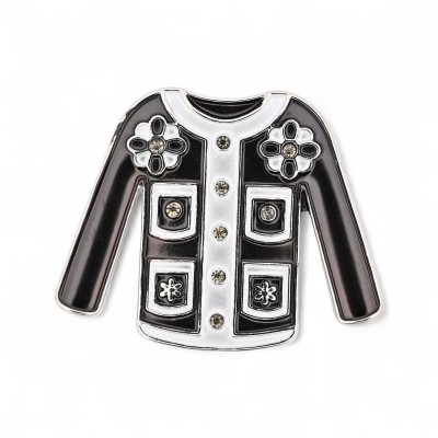 Black and white jacket brooch in silver-tone metal built on Parisian cardigan codes: black enamel body with white edges, white r
