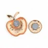 Back view of the red apple brooch showing the engraved rose gold finish and the circular dual magnet disc