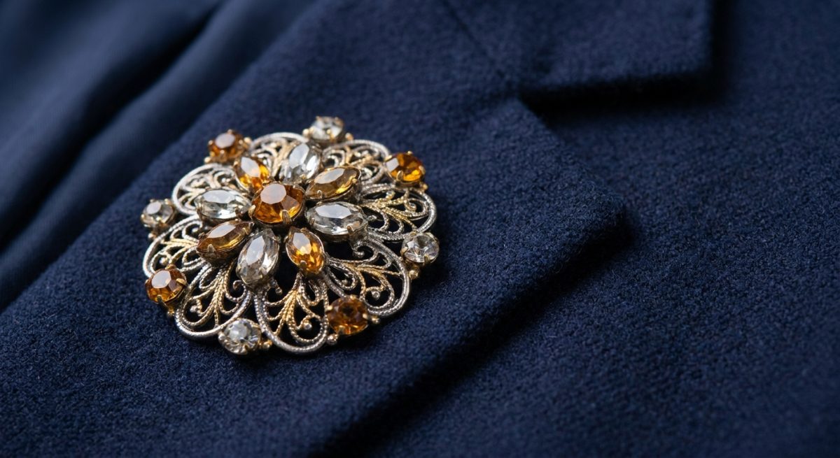 Broche ornee epinglee sur le revers gauche d'une veste structuree